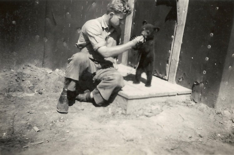 POW and pet bear, Pigeon Timber Co. Camp near Neys.